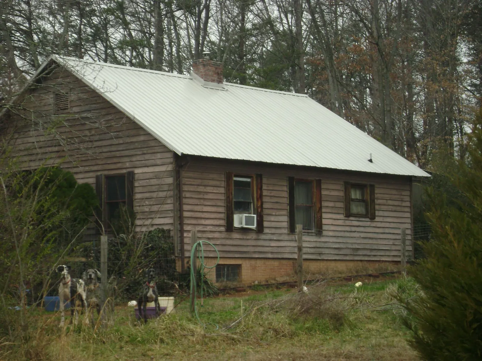 White metal roof on an old wood sided farmhouse, from a Asphalt Shingle Roof Repair job in Charlotte Court House